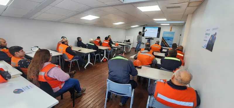 Operarios con chalecos reflectantes en una sesión de capacitación técnica
